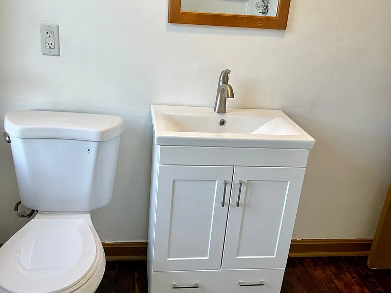Second full bathroom with vanity, toilet, and full tub