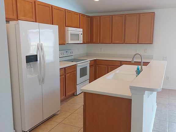 Kitchen with roll out shelving, newer refrigerator