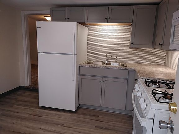 Note the under counter lighting and new gas stove, refrigerator and microwave