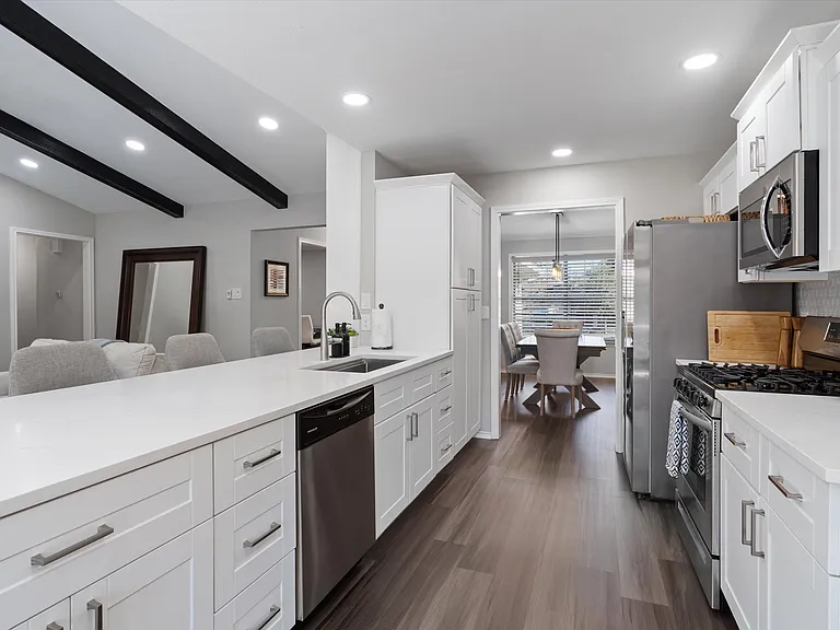Open Concept Kitchen with all brand new appliances and Island Seating for 4 and breakfast table and extra storage in breakfast area.