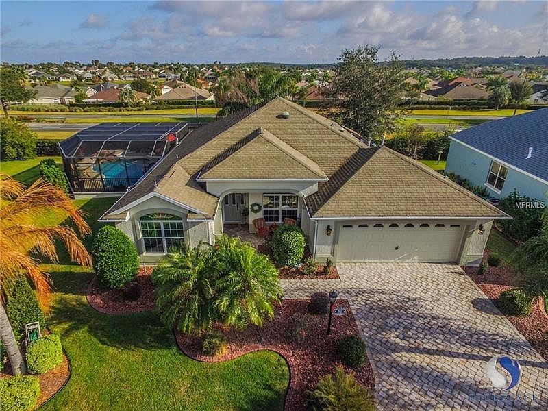 Gorgeous Gardenia with pool! As you walk up to the home you will notice the pride of ownership with the Professional Landscape and curbing with Brick Paver drive way!