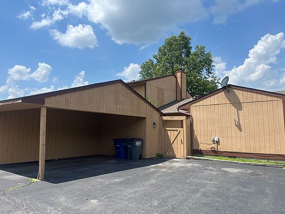 carport with gated patio area leading to rear entry