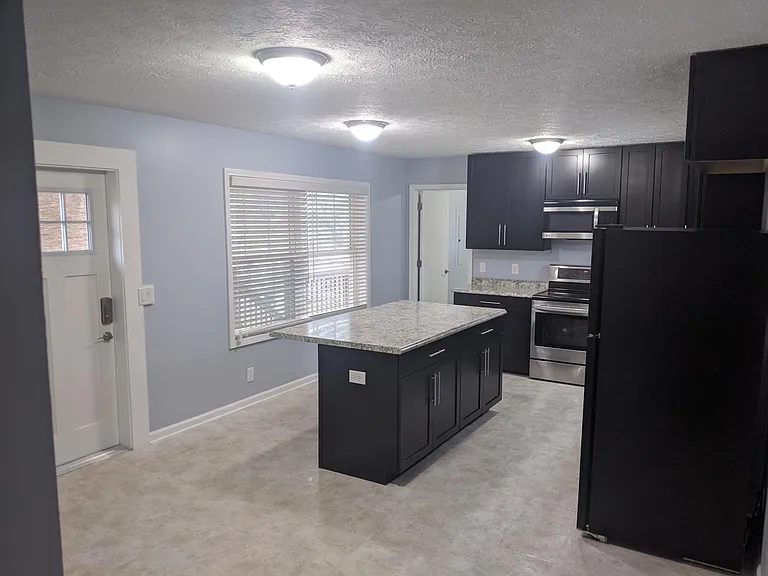 kitchen viewed from the dining area. showing the door to the back covered deck