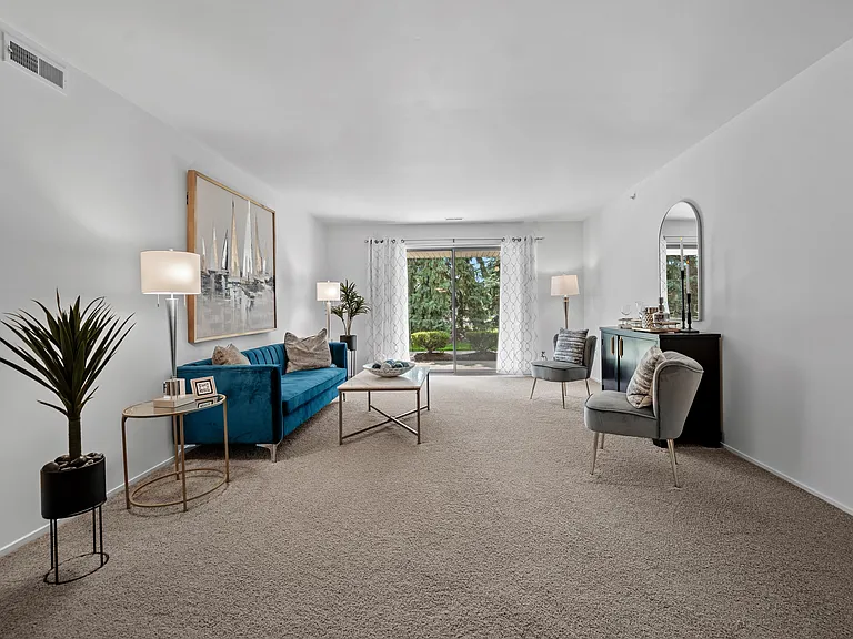 Spacious Living room with patio at Prentiss Pointe Apartments in Harrison Township