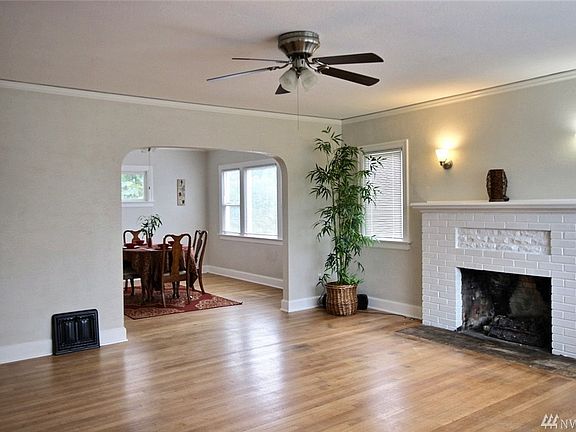 The living room offers a gas fireplace with brick mantel, crown molding, and all new ceiling fan and sconces.  Please also note that hardwood flooring is through almost the entire home upstairs and downstairs.  