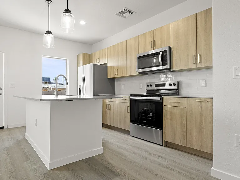 Kitchen with stainless steel appliances and center median