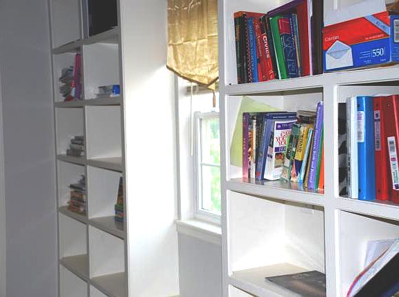 Nice window lets in light in the middle of the book case.