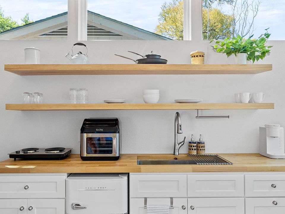 Full kitchen with electric stove top appliance and an air fryer! Easily stored when not being used to maximize counter space; tea & coffee available (but top notch coffee shops within walking distance!)