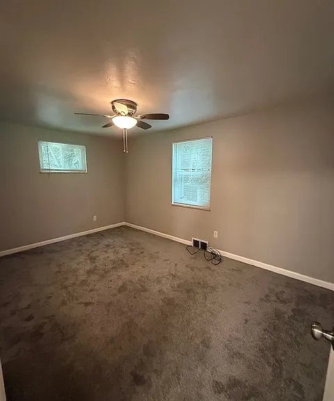 Main bedroom in backmost corner of home surrounded by grennery.