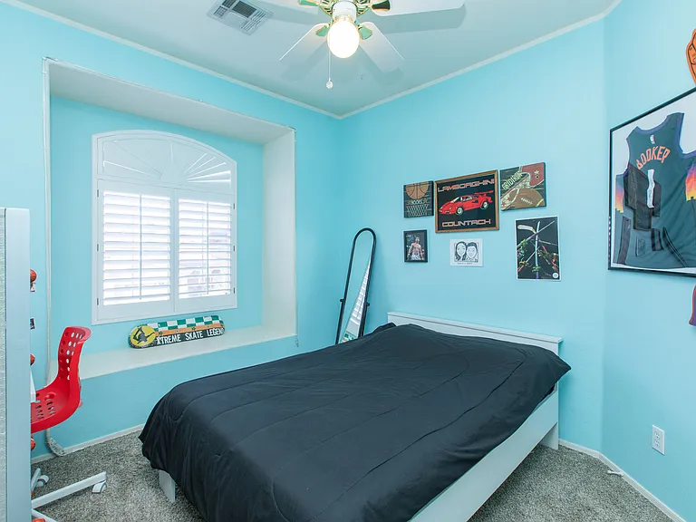 upstairs bedroom 2 featuring window bench & wood shutters