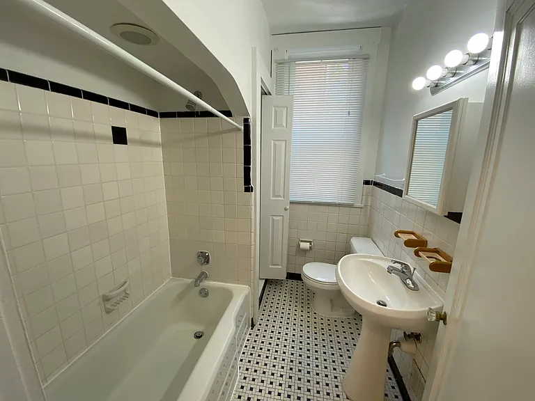 Bathroom with tub and linen closet