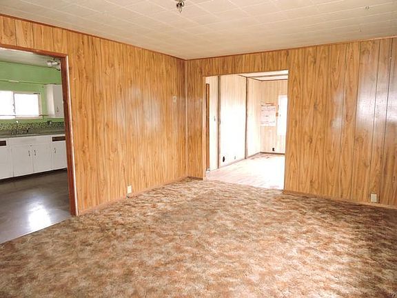 FRONT LIVING ROOM LOOKING INTO KITCHEN AREA AT LEF