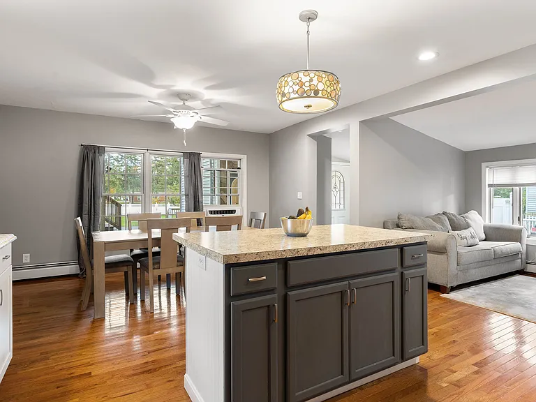 Kitchen Island, Granite Countertops, Open Concept, Pendant Lighting, Hardwood Floors, Modern Cabinets, Recessed Lighting.