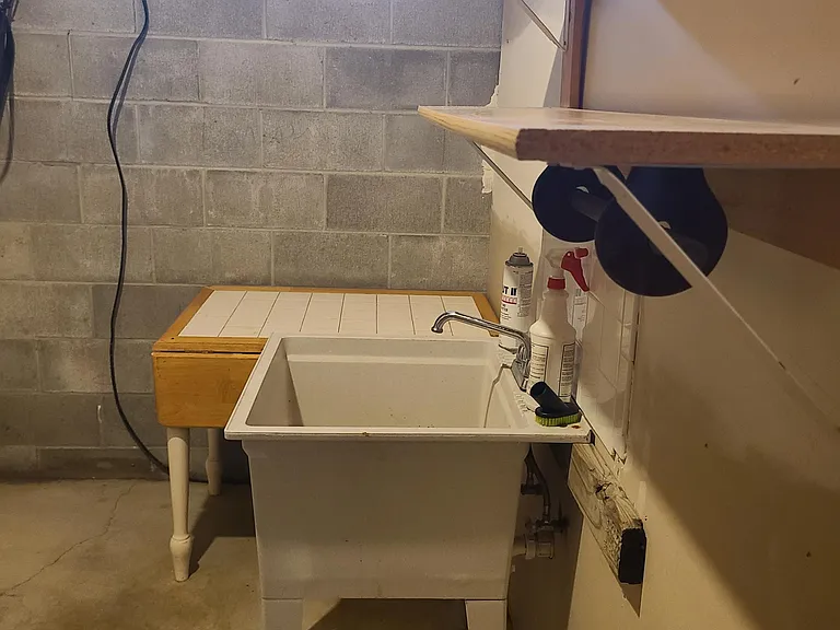 Large laundry utility sink and shelving