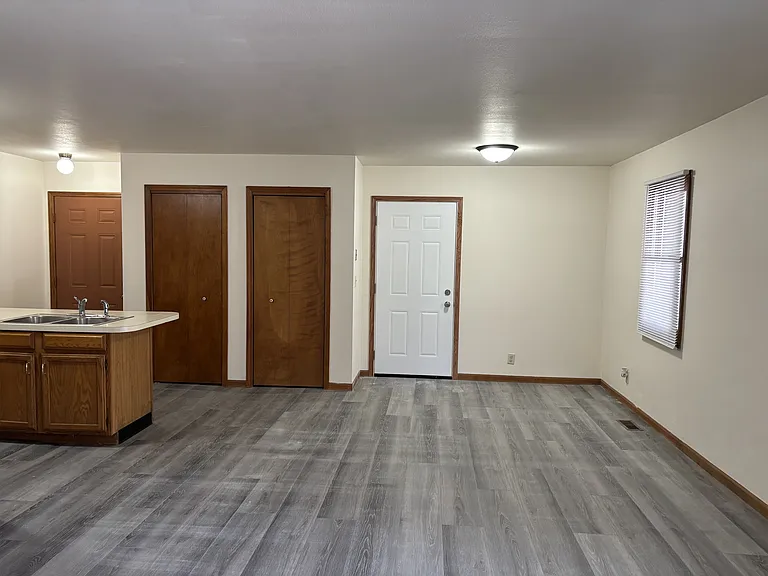 Dining area with front door to the left, entry door to garage on the right.