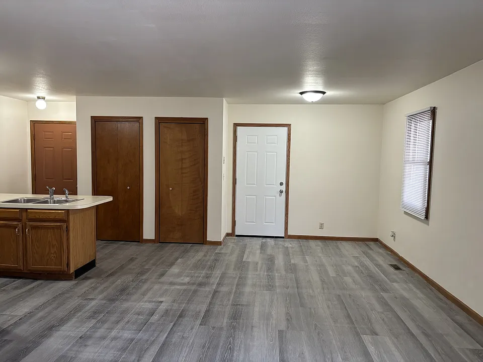 Dining area with front door to the left, entry door to garage on the right.