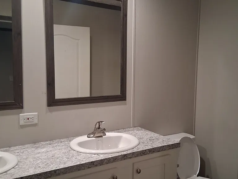 Double vanity in the primary bedroom ensures privacy and a chance to relax.