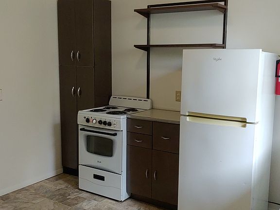 Kitchen with custom painted classic period metal cabinets, newer appliances and just installed new flooring.