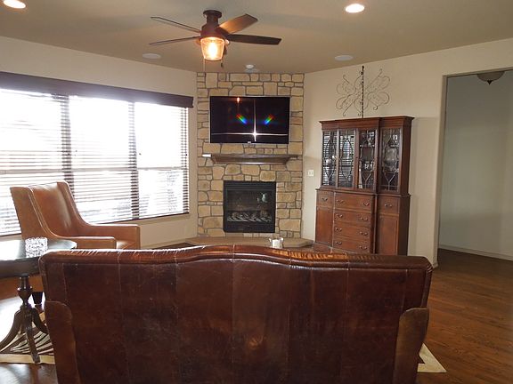 Family room fireplace with recessed lighting and gas firepla