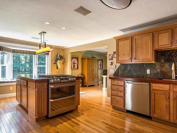 Spacious eat-in kitchen with gleaming hardwood floors and radiant cherry wood countertops.