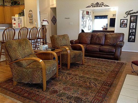 In this view of family room, note the game room in background and kitchen to the left