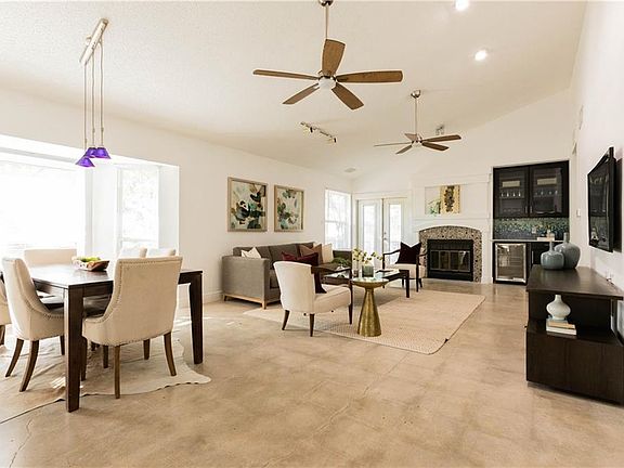 Vaulted ceilings and ample light in your dining, open living with dry bar and French doors to your outdoor living sanctuary