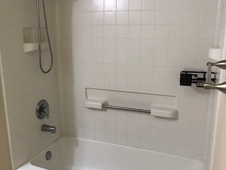 Bedroom 1 has full tub and shower newer fixtures.