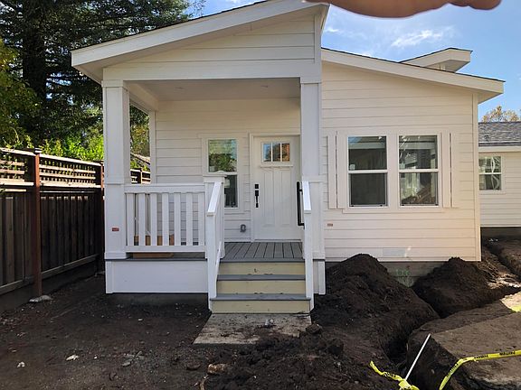 View of front. 70 square foot porch. Landscaping with private patio coming soon!