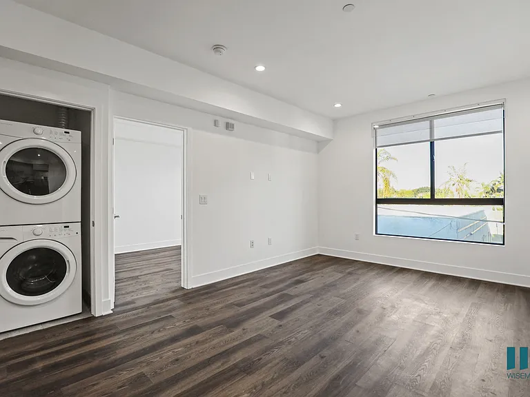 In-Suite Washer& Dryer, Living zoom with Large-Windows, Recessed Lighting, and Vinyl Flooring
