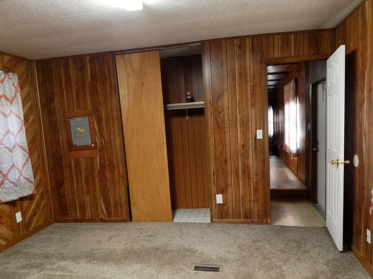Master bedroom -window on the left -closet at center - entrance from front of home on the right