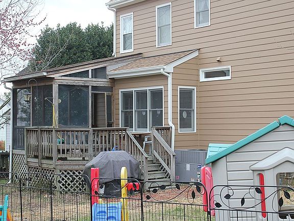 Screened porch leading onto deck with built-in seating