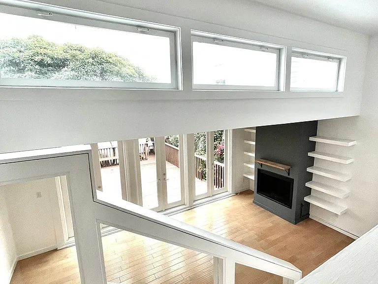 Stairs leading down to living room and outdoor deck