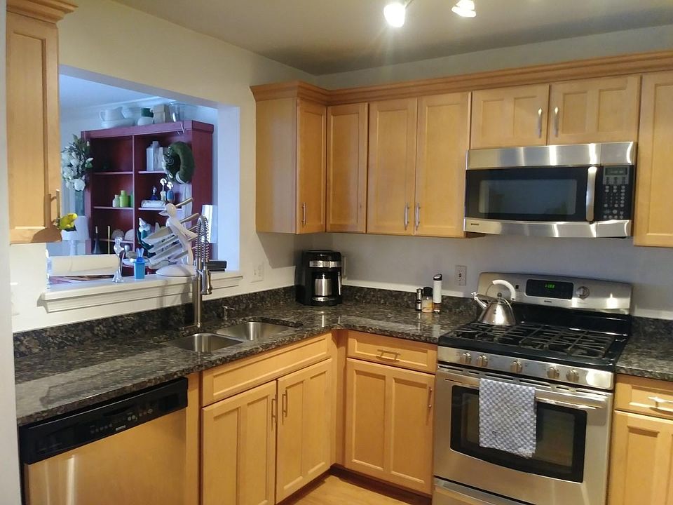 Kitchen with granite counter tops and steel appliances.