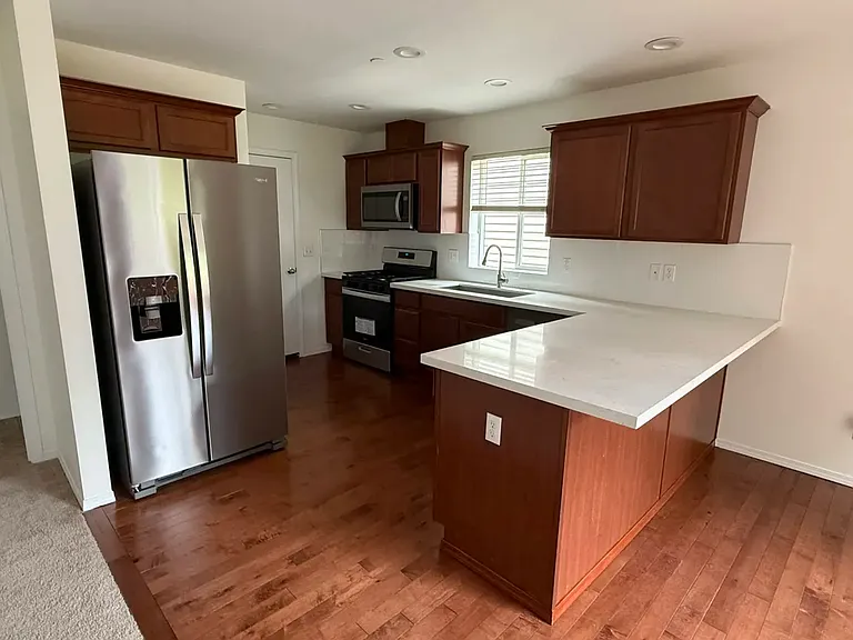 Spacious kitchen with stainless steel appliances and plenty of cabinet storage.