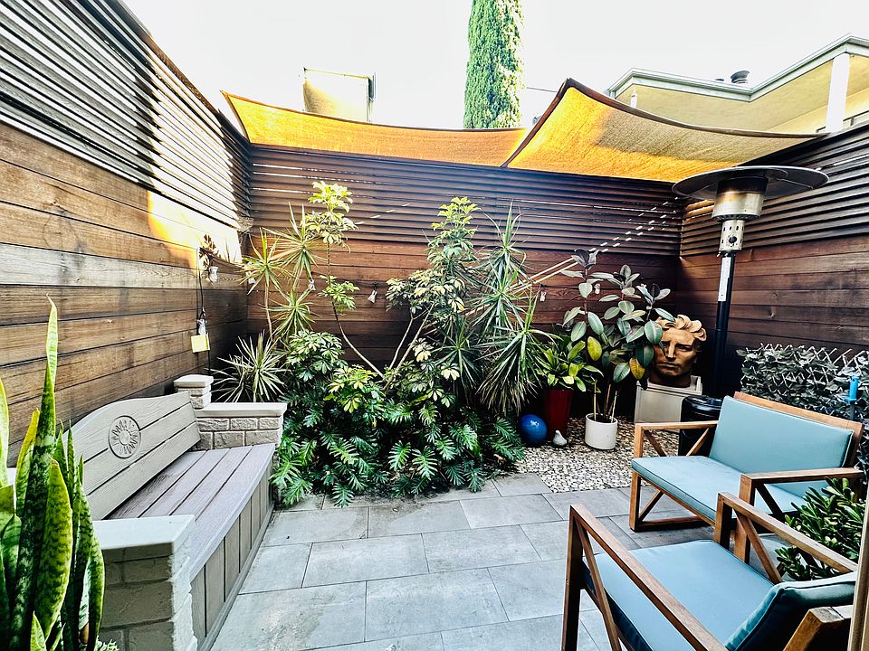 Remodeled outdoor patio with finished wood and molded concrete with awning to enjoy San Diego daylight and evenings. Plants are built in with built in drainage. Patio bench and heat lamp included with rental.