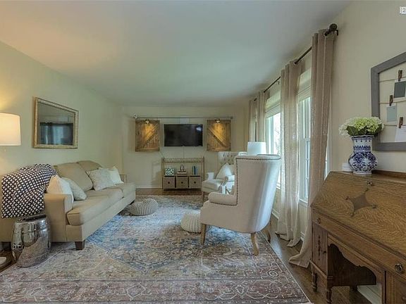 SPACIOUS LIVING ROOM, REDONE HARDWOOD FLOORS, WINDOW COVERINGS REMAIN