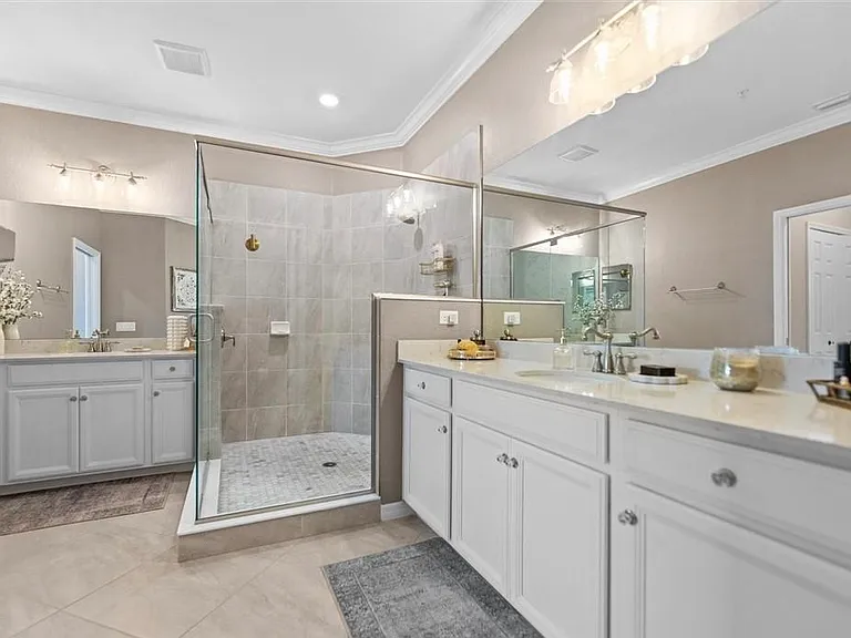 Master Bathroom with double vanity and walk-in shower with marble tile floor