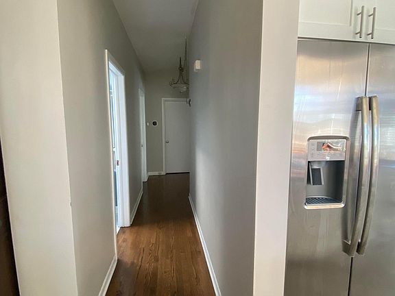 Hallway (half bath on left, kitchen and 2 bedrooms on the right)