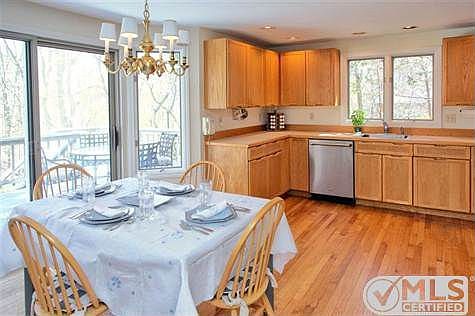 Kitchen with dining area and access to spacious deck and private back yard.