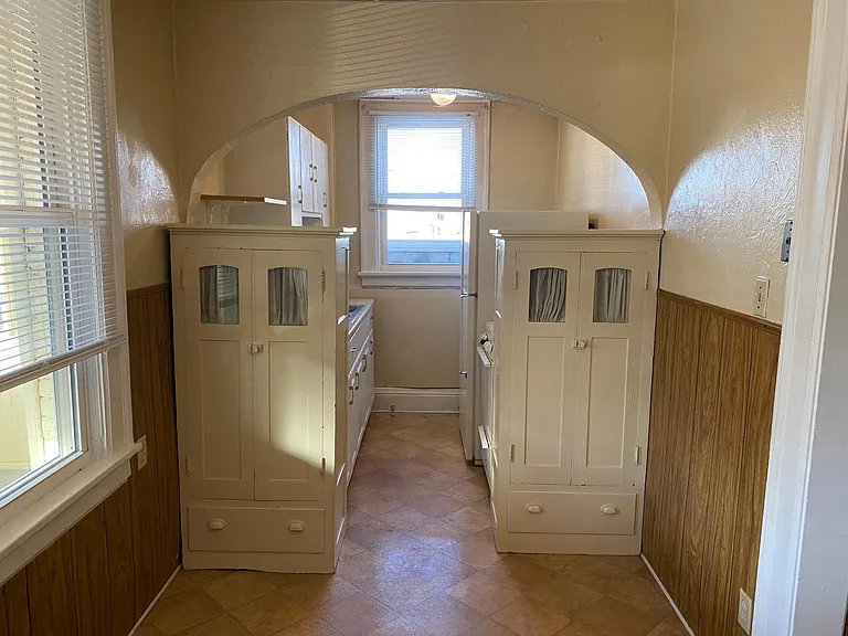 Standing in eating area, looking toward kitchen.