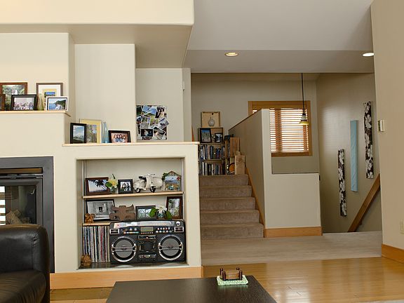 Living room, facing stairs up to the Primary Suite, and stairs down to lower level.