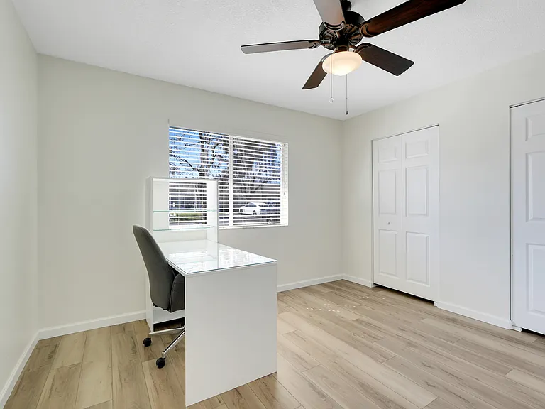 Conveniently located guest bathroom with a granite countertop vanity and shower-tub combo, perfectly positioned between the primary suite and guest bedroom.