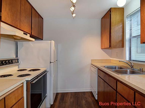 Kitchen with all essential appliances including dishwasher and microwave