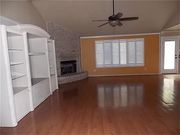 SPACIOUS DEN WITH FIREPLACE AND LAMINATE FLOORING