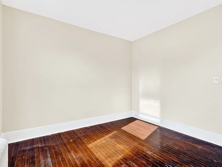 Bedroom with hardwood floors.