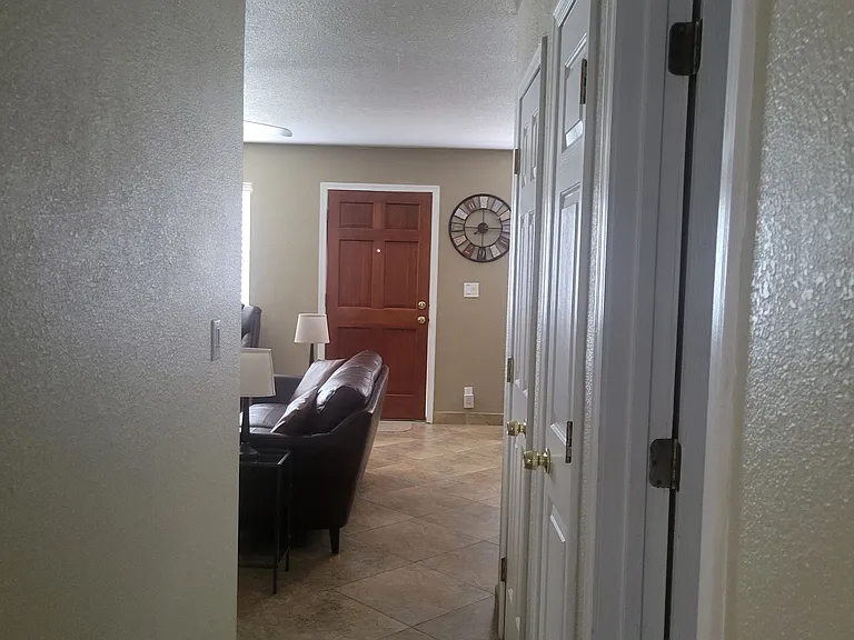 View from hallway exiting the bedrooms to front door.