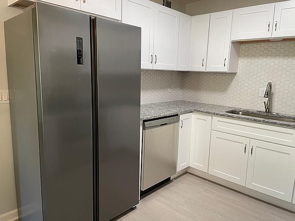 Kitchen with beautiful new counter-depth side-by-side large fridge.