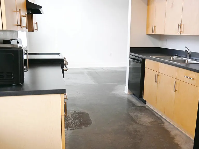 Kitchen view next to the lviing room in a unit at The Sawyer.