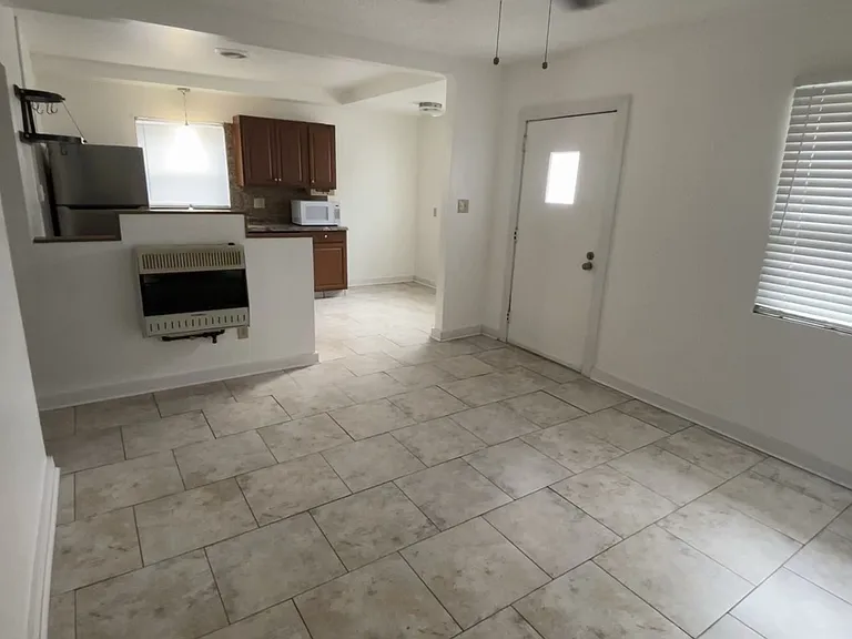 Bright, neutral warm tones tile flooring throughout the entire house.