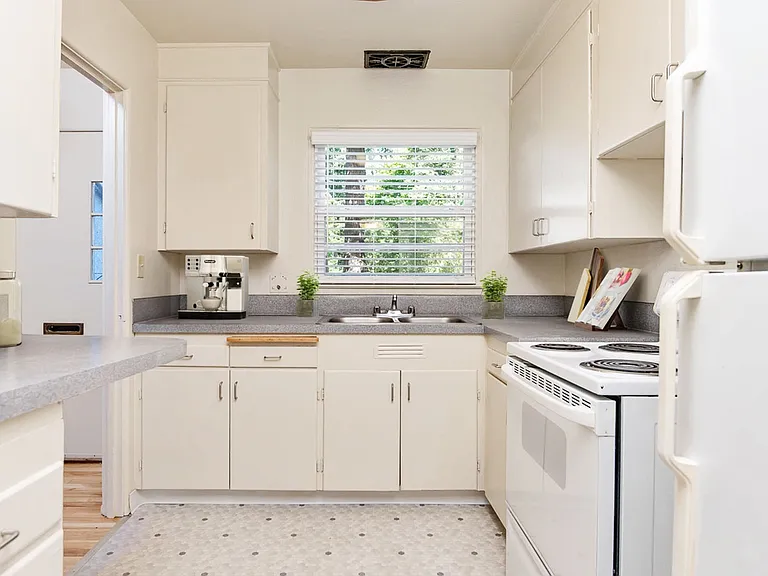White Cabinets Kitchen with Gray Counters and Classic Flooring